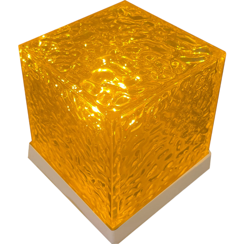 A glowing cube-shaped lamp with a textured, honeycomb-like translucent yellow-orange glass top and a white base, shown on a plain white background.