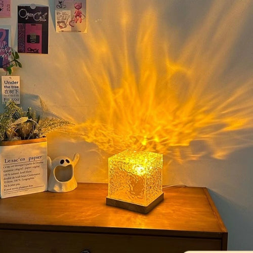 Decorative lamp casting a warm glow on a wall with a wooden surface and plants in the background.